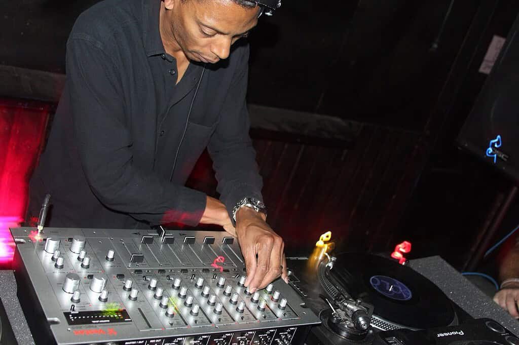 Techno Genres and Subgenres: 12 Types of Techno Explained (2026) 1 Jeff Mills, Underground Resistance co-founder, mixing vinyl records on a Vestax DJ mixer