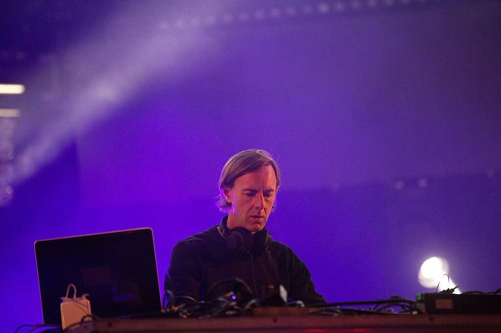 Techno Genres and Subgenres: 12 Types of Techno Explained (2026) 3 Richie Hawtin playing a minimal techno set under purple light at SonneMondSterne 2018