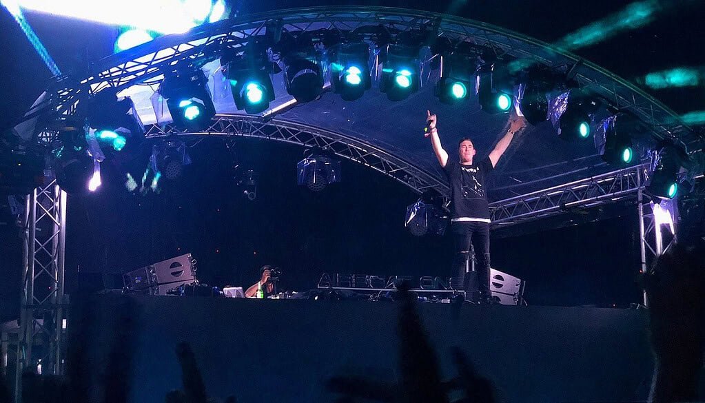 Hardwell, founder of Revealed Recordings, raises both arms on the Airbeat One 2018 stage under blue lights Hardwell, founder of Revealed Recordings, raises both arms on the Airbeat One 2018 stage under blue lights