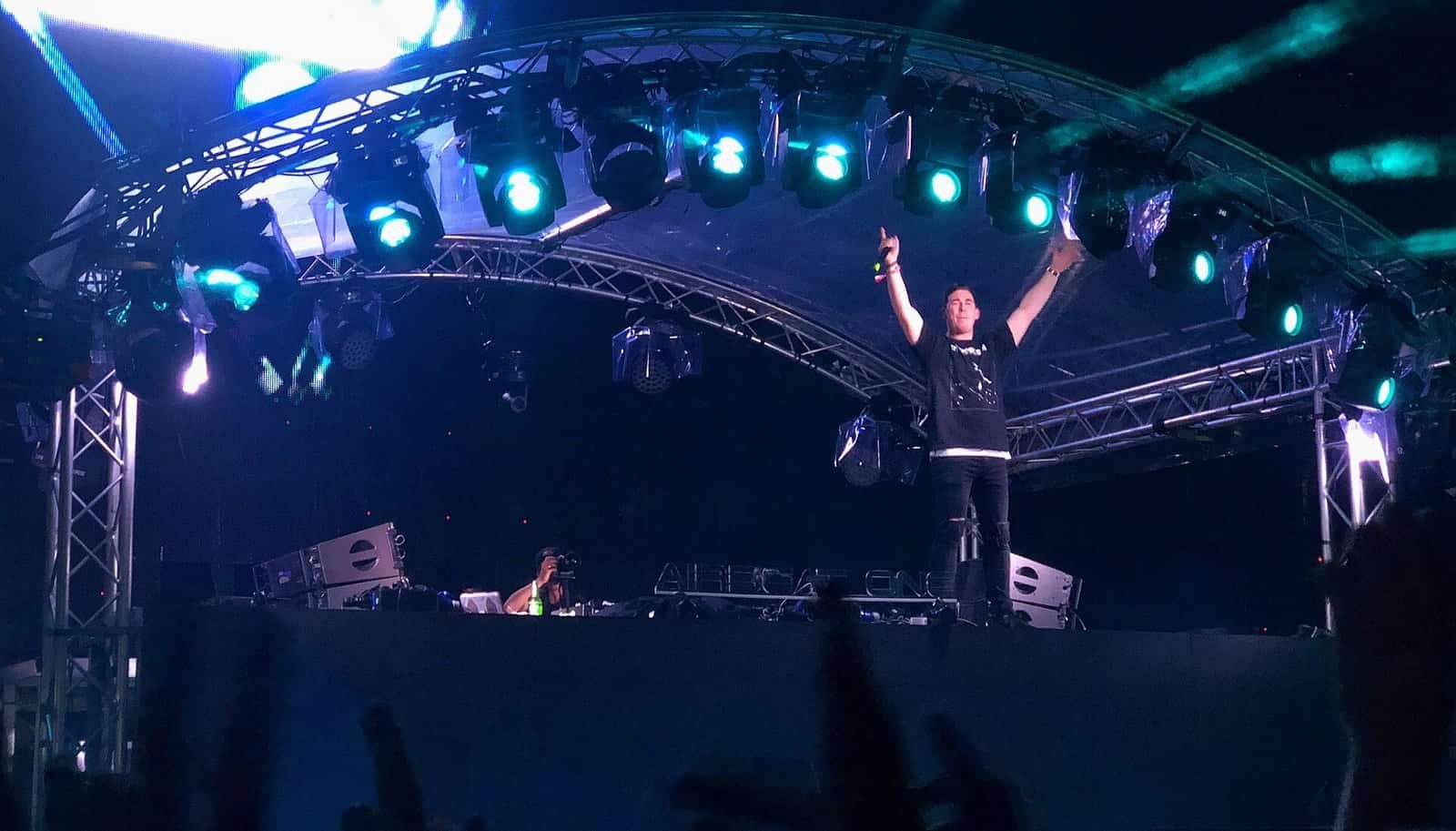Hardwell, founder of Revealed Recordings, raises both arms on the Airbeat One 2018 stage under blue lights Hardwell, founder of Revealed Recordings, raises both arms on the Airbeat One 2018 stage under blue lights