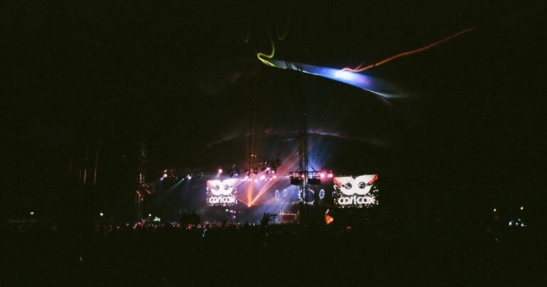 Carl Cox performing on a festival stage at night