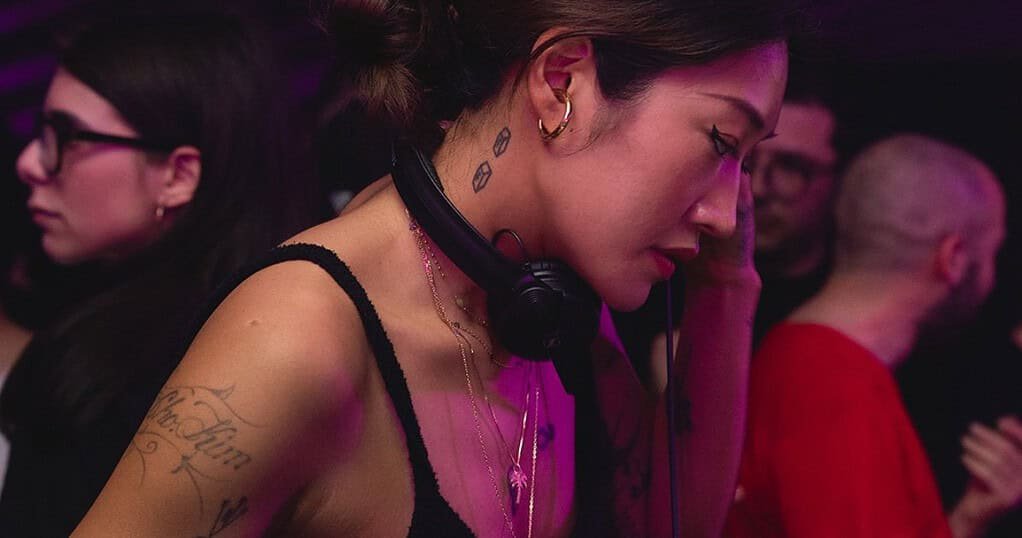 Peggy Gou DJing with headphones at a festival