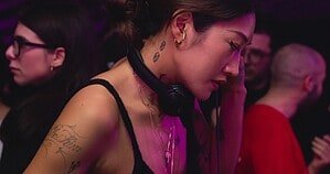 Peggy Gou DJing with headphones at a festival Peggy Gou DJing with headphones at a festival