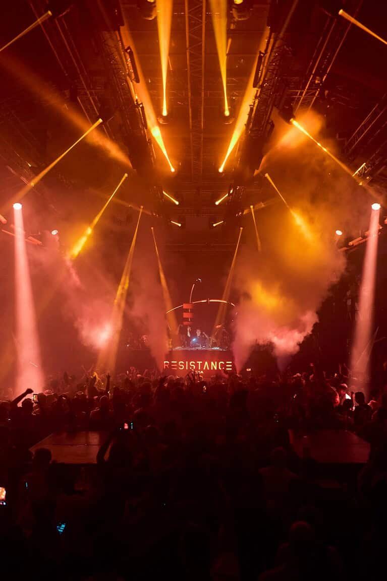 RESISTANCE illuminated booth and orange lasers over the crowd at Amnesia during the 2026 opening party