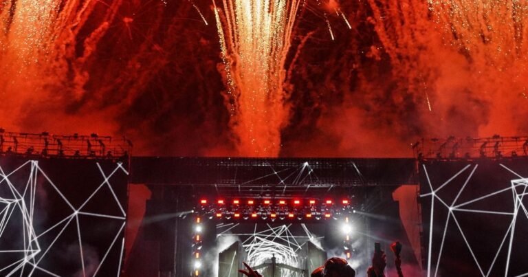 Fireworks bursting over a festival mainstage at night, the kind banned at Tomorrowland 2026 Weekend One