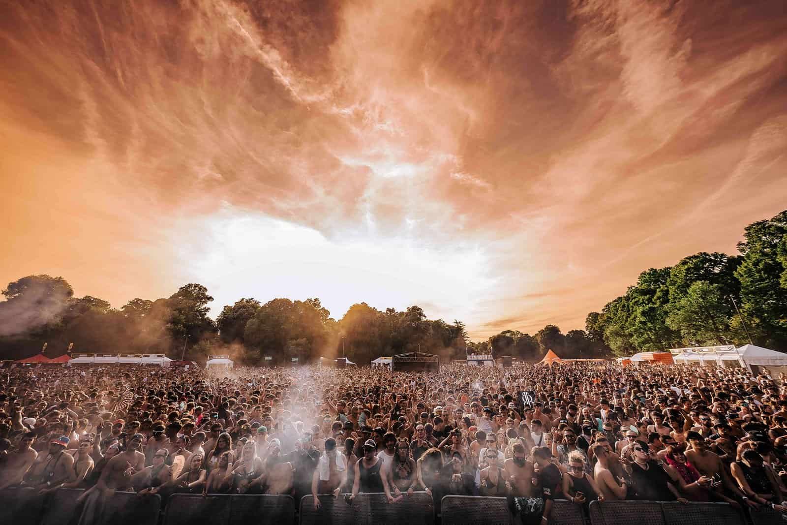 Decibel Open Air 2026 at Parco delle Cascine Decibel Open Air crowd in the park at sunset, official festival photo from decibelopenair.com