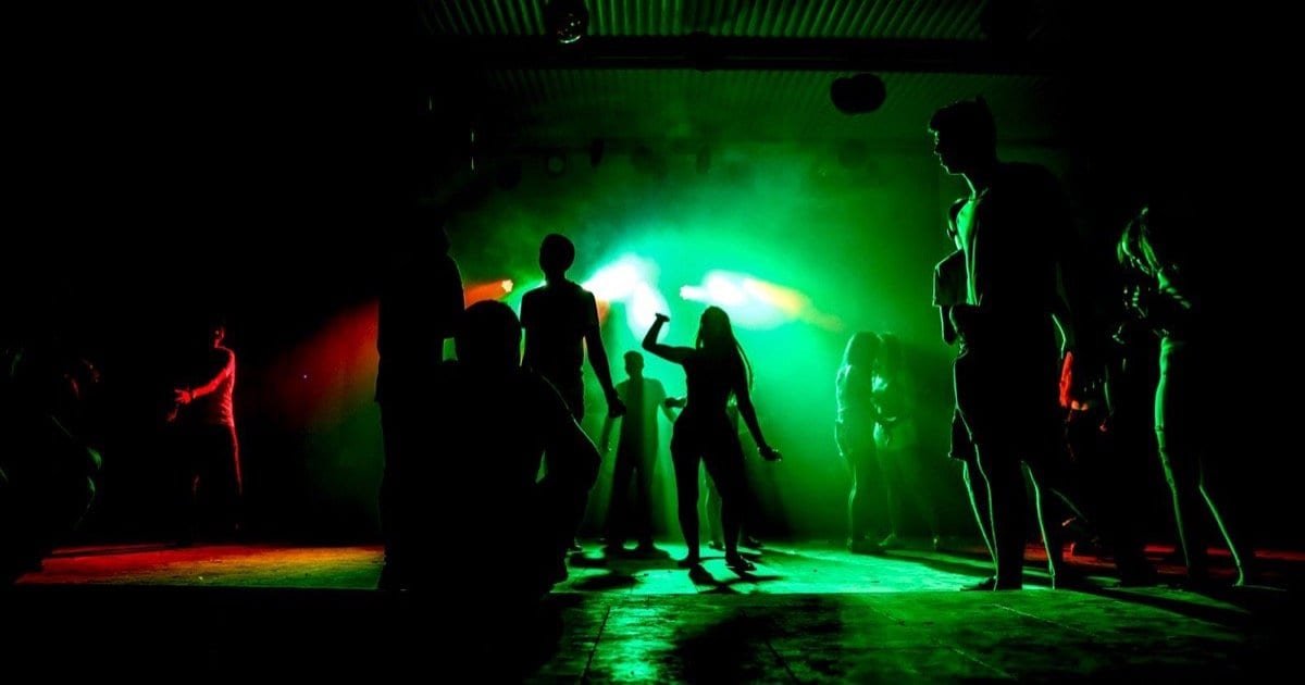 Silhouetted crowd on a dark club dancefloor, illustrating the hard techno scene accountability debate in 2026 Silhouetted crowd on a dark club dancefloor, illustrating the hard techno scene accountability debate in 2026