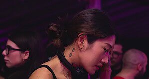 Peggy Gou DJing in a club with headphones, 2019 Peggy Gou DJing in a club with headphones, 2019
