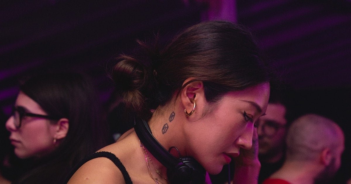 Peggy Gou DJing in a club with headphones, 2019 Peggy Gou DJing in a club with headphones, 2019