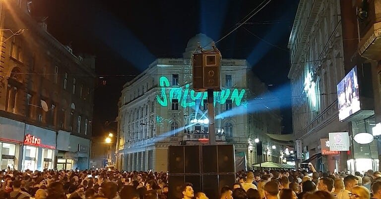 Crowd at Solomun's free street show in Sarajevo with his name projected on a building Crowd at Solomun's free street show in Sarajevo with his name projected on a building