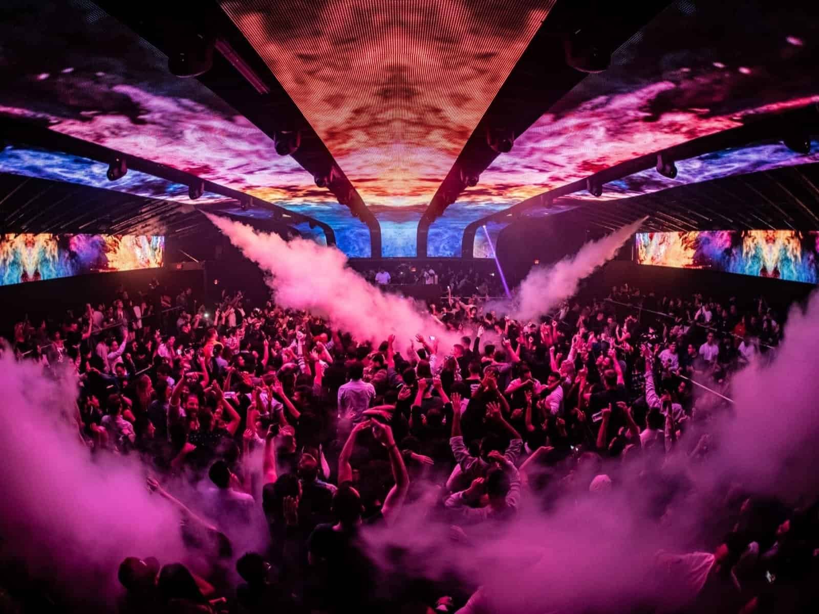 Academy LA crowd under curved LED ceiling panels with CO2 jets firing over the floor
