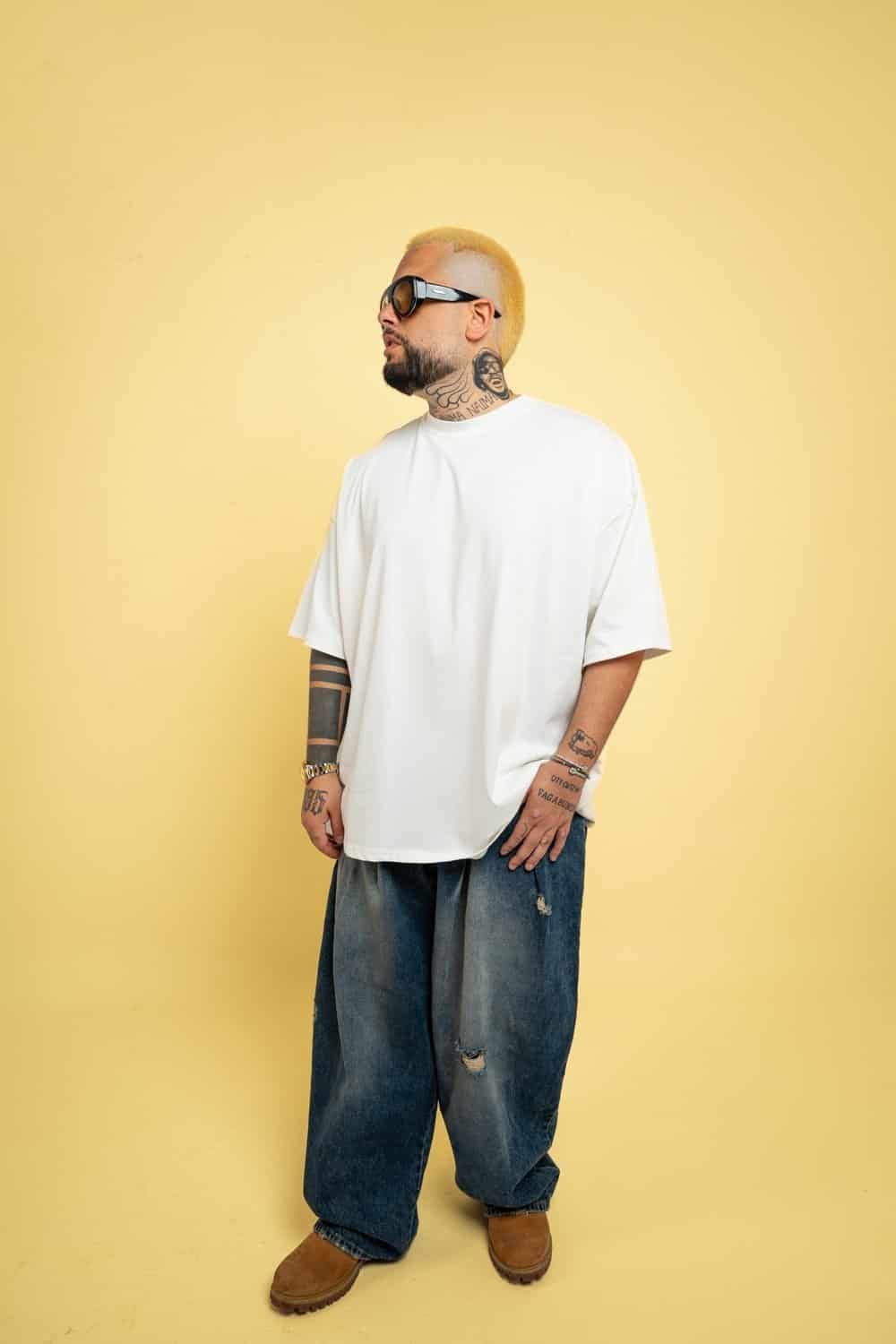 Joseph Capriati and GENNARO Team Up on 'Control' for Metamorfosi Records 1 GENNARO press photo in white t-shirt and sunglasses against a yellow backdrop