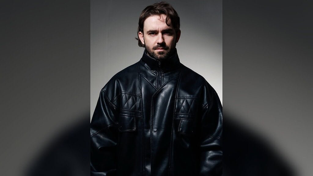 Studio portrait of Kevin Brauer in a black leather jacket Studio portrait of Kevin Brauer in a black leather jacket