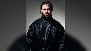 Studio portrait of Kevin Brauer in a black leather jacket