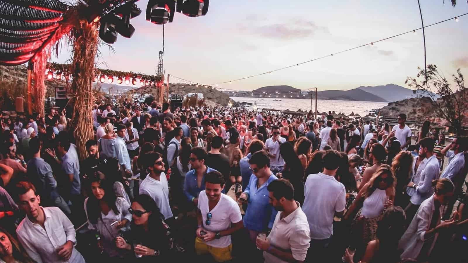 The Best Beach Clubs in Europe for 2027 3 Afternoon crowd at Alemagou on Ftelia Beach in Mykonos with the bay in the background