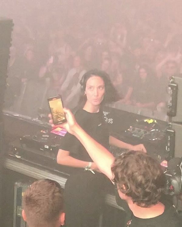 Highest-Paid Female Techno DJs 2026: Amelie Lens, Charlotte de Witte and 12 More 1 Amelie Lens behind the decks at Ikarus Festival 2022, fans filming from the booth