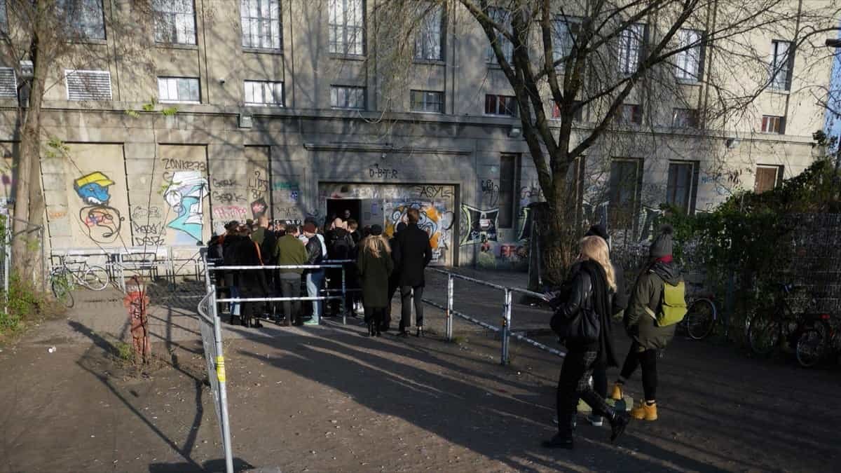 How to Get Into Berghain in 2026: Door Policy, Dress, Prices and Hours 1 The queue outside the Berghain entrance in Berlin, with people waiting at the door of the former power station