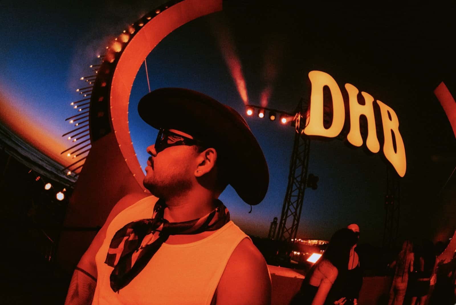 DHB Portugal 2026 in Photos: 10 Moments From Costa da Caparica 4 Festivalgoer under the stage lights at DHB Portugal 2026