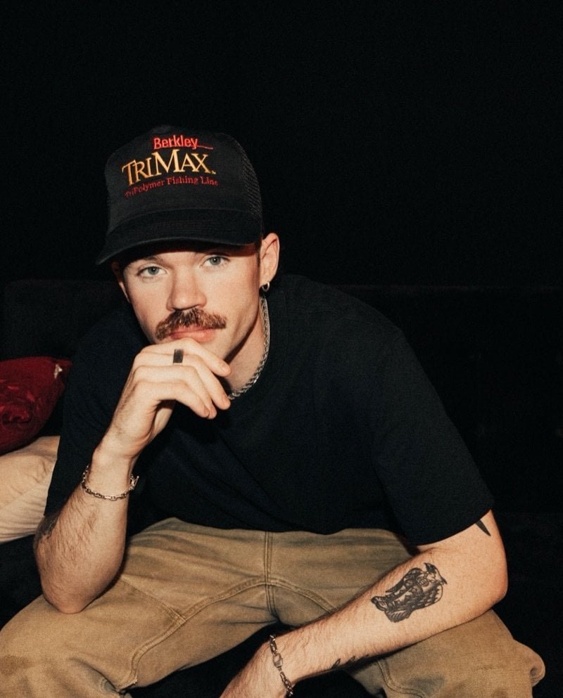 Dom Dolla portrait in a black cap and t-shirt, photographed in 2024