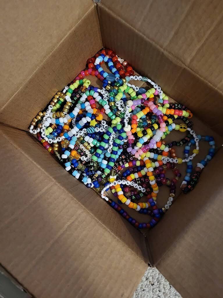 PLUR: The Heartbeat of Rave Culture 3 Box full of handmade rainbow pony bead kandi bracelets ready to trade at a rave