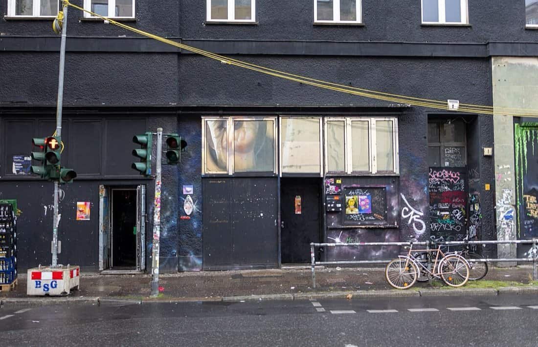 Photos & Videos From Inside KitKatClub: Berlin's Most Infamous Club 1 KitKatClub Berlin entrance doors on Köpenicker Straße, black facade with graffiti