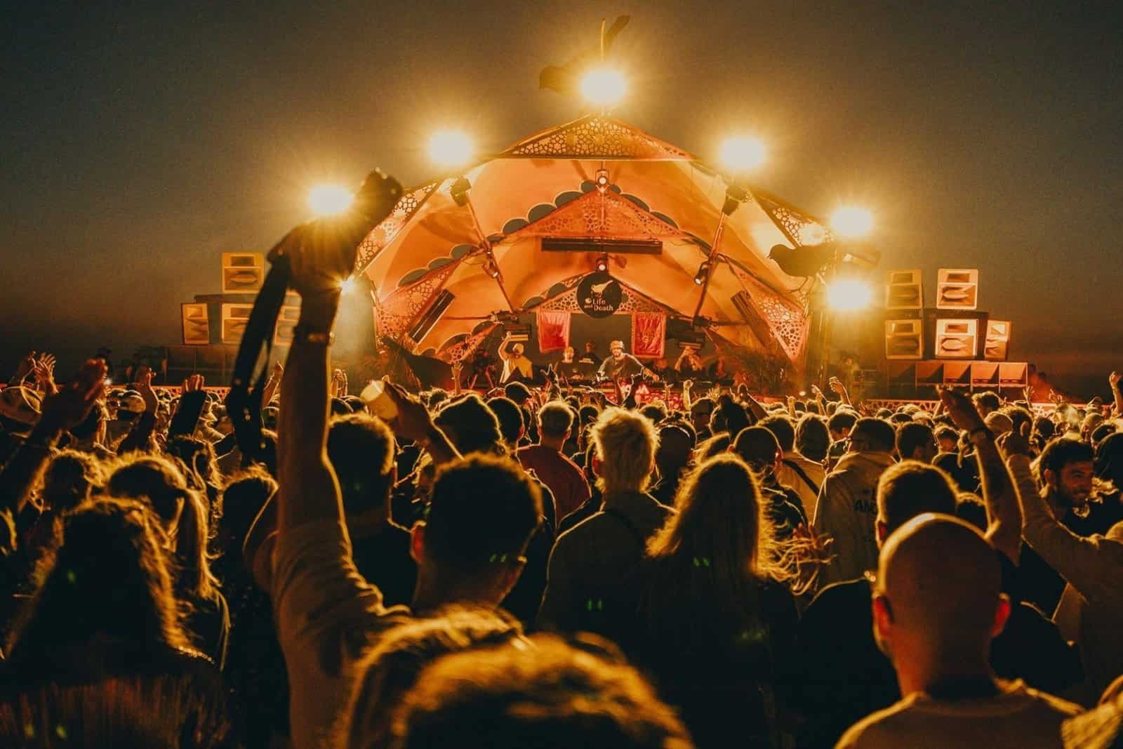 Nine Destination Festivals Worth Travelling For in 2026 and 2027 8 Crowd with raised hands in front of the main stage at MOGA Festival in Essaouira, Morocco