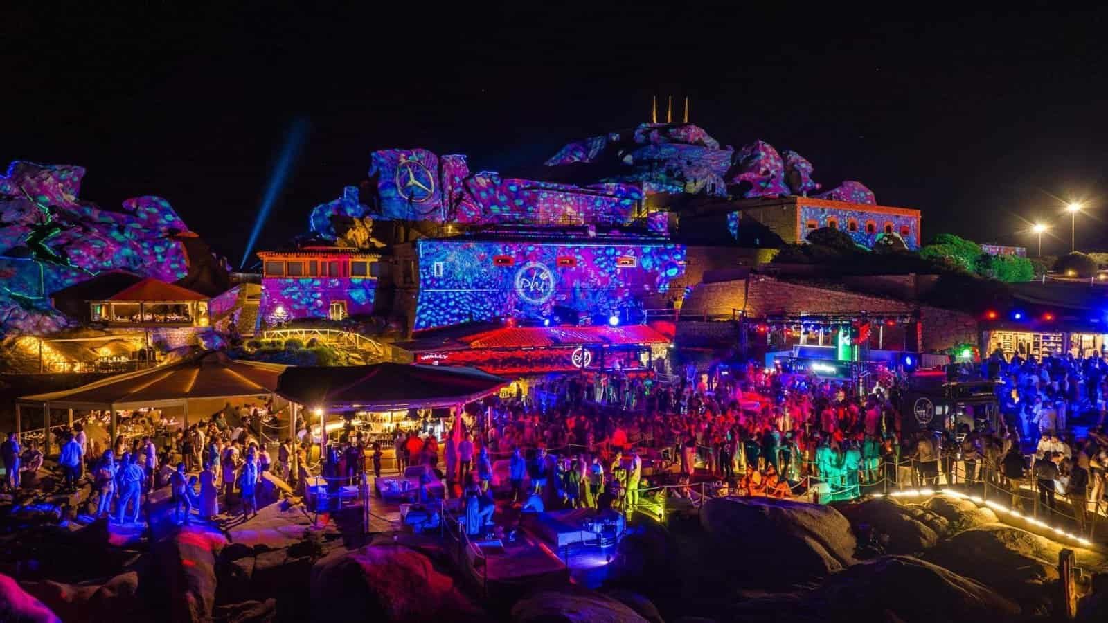 The Best Beach Clubs in Europe for 2027 1 Night session at Phi Beach in Baja Sardinia, with projections across the granite rocks above the dancefloor