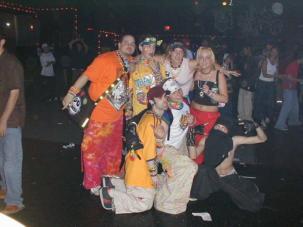 PLUR: The Heartbeat of Rave Culture 1 Group of kandi kid ravers in phat pants and bead necklaces at an early 2000s rave, the scene where PLUR took root