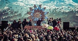 Rave On Snow crowd in front of a mountain stage on the Schattberg above Saalbach-Hinterglemm, one of Europe's winter techno festivals