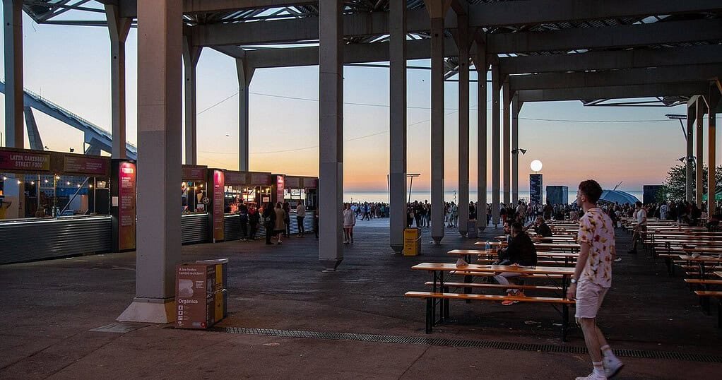 Festival food court at dawn at Primavera Sound Barcelona, where ravers refuel after an all-night set Festival food court at dawn at Primavera Sound Barcelona, where ravers refuel after an all-night set