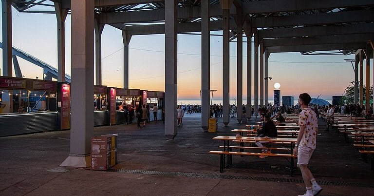 Festival food court at dawn at Primavera Sound Barcelona, where ravers refuel after an all-night set Festival food court at dawn at Primavera Sound Barcelona, where ravers refuel after an all-night set