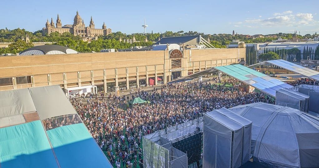 Crowd at Sónar by Day at Fira Montjuïc in Barcelona, with the National Palace on the hill behind