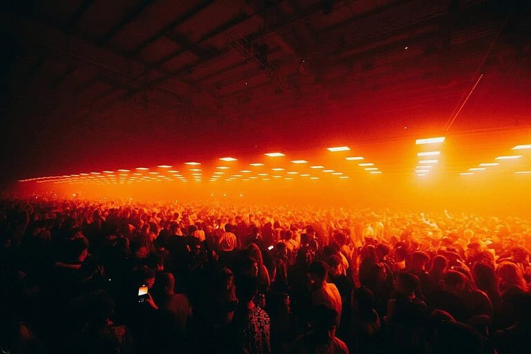 terminal v techno crowd orange warehouse lights