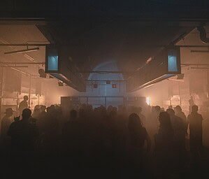 TILLATEC club in Amsterdam, a crowd in haze in the main hall
