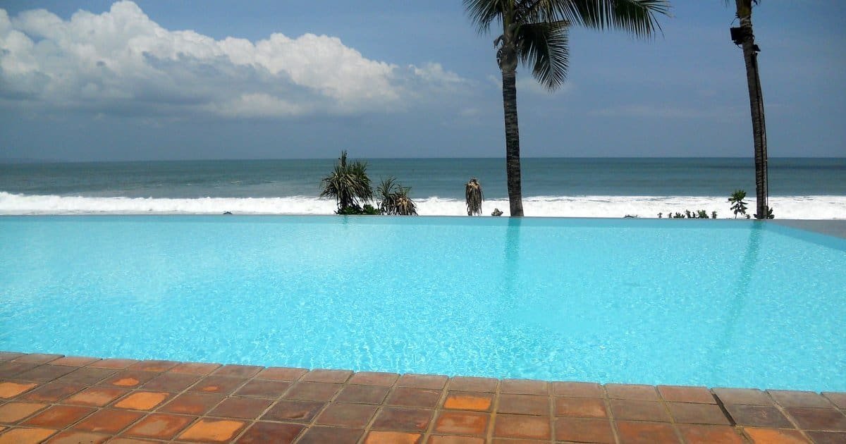 Infinity pool overlooking the Indian Ocean surf at Potato Head Beach Club in Seminyak, Bali, one of the best beach clubs in the world