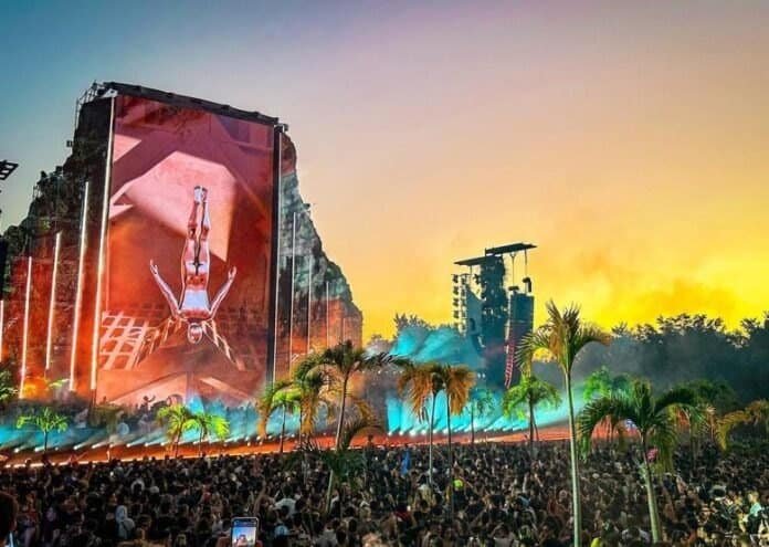 Nine Destination Festivals Worth Travelling For in 2026 and 2027 3 Zamna Festival main stage with giant screen at dusk, crowd and palm trees in Tulum